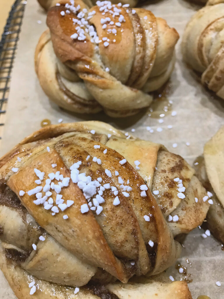 Swedish Buns baked and topped with sugar glaze and pearl sugar