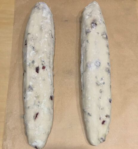 Proofed baguettes on parchment