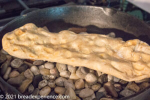 Sangak baked on pebbles in cast iron skillet