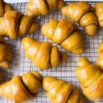 Sourdough Einkorn Pumpkin Crescent Rolls brushed with butter