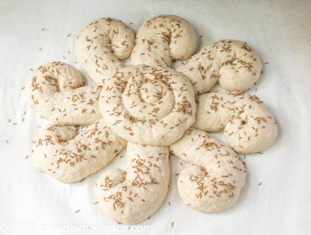 Shaped Sourdough Sunshine Loaf sprinkled with seeds